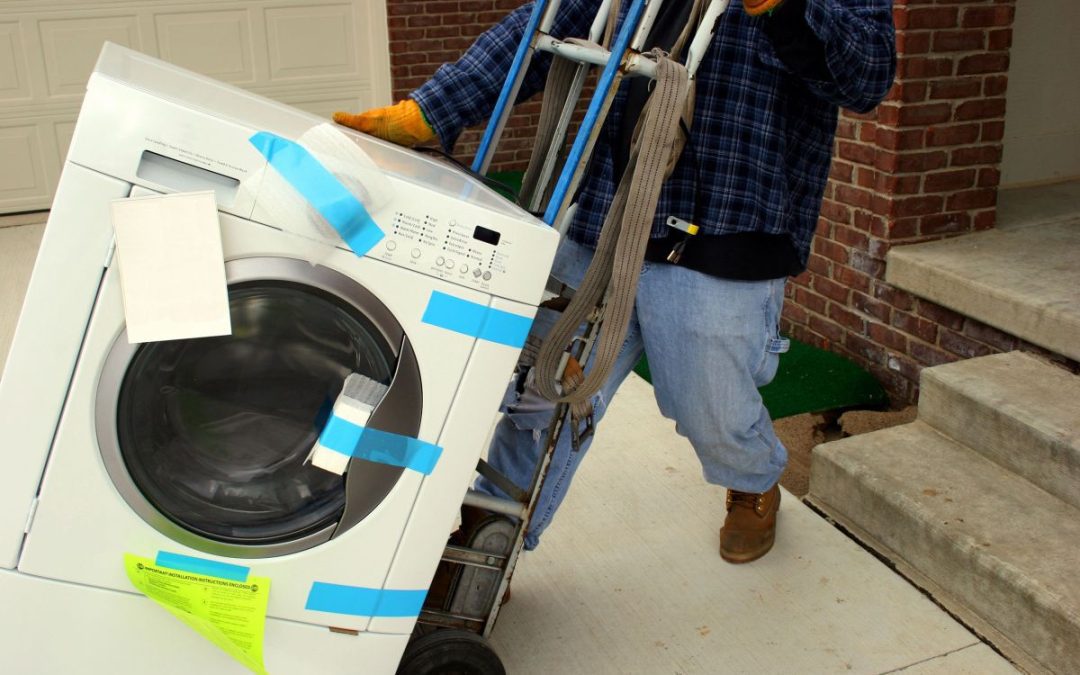 A washing machine being delivered using a special trolley | Britannia Alan Cook