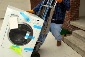 A washing machine being delivered using a special trolley | Britannia Alan Cook