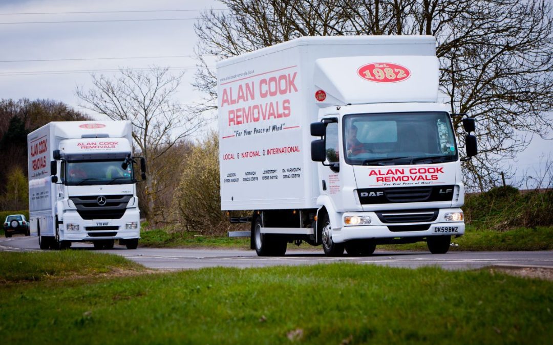 Two Alan Cook Removals Lorries loaded for moving items and packages