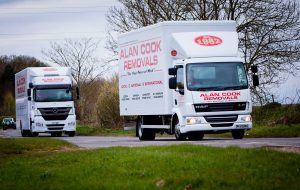 Two Alan Cook Removals Lorries loaded for moving items and packages