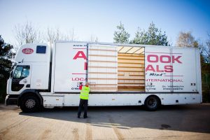 Britannia Alan Cook Removals Team opening the side doors of a lorry to start loading